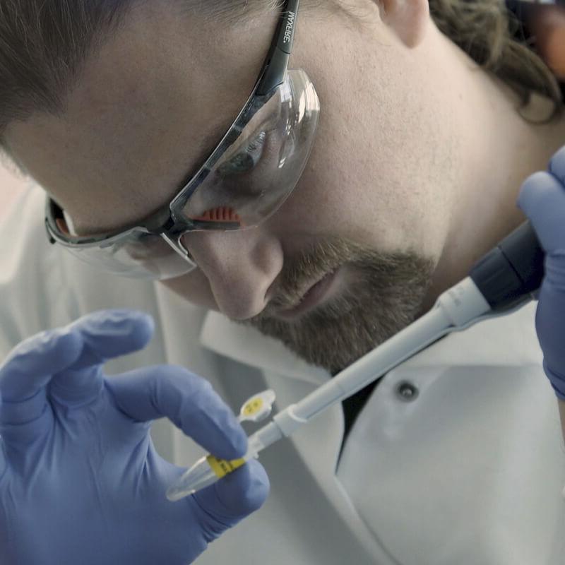 Image: Lab technician filling vial
